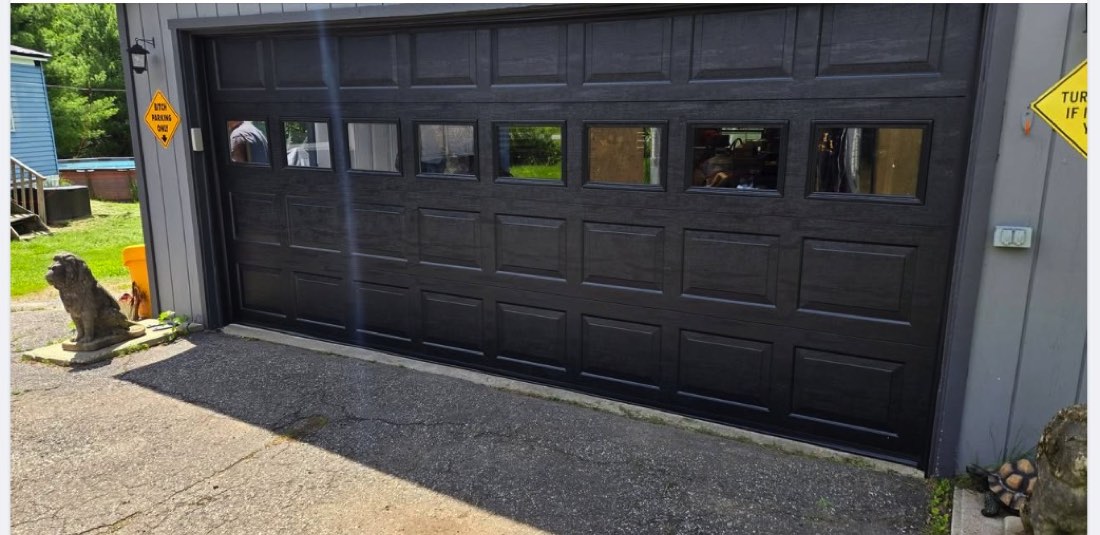 Garage door installed on gray-sided building