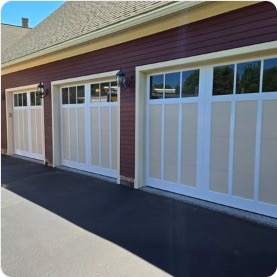 Three-bay commercial garage doors on red building