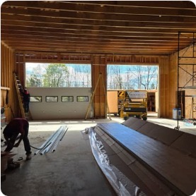 Crew working inside multi-bay barn on garage doors